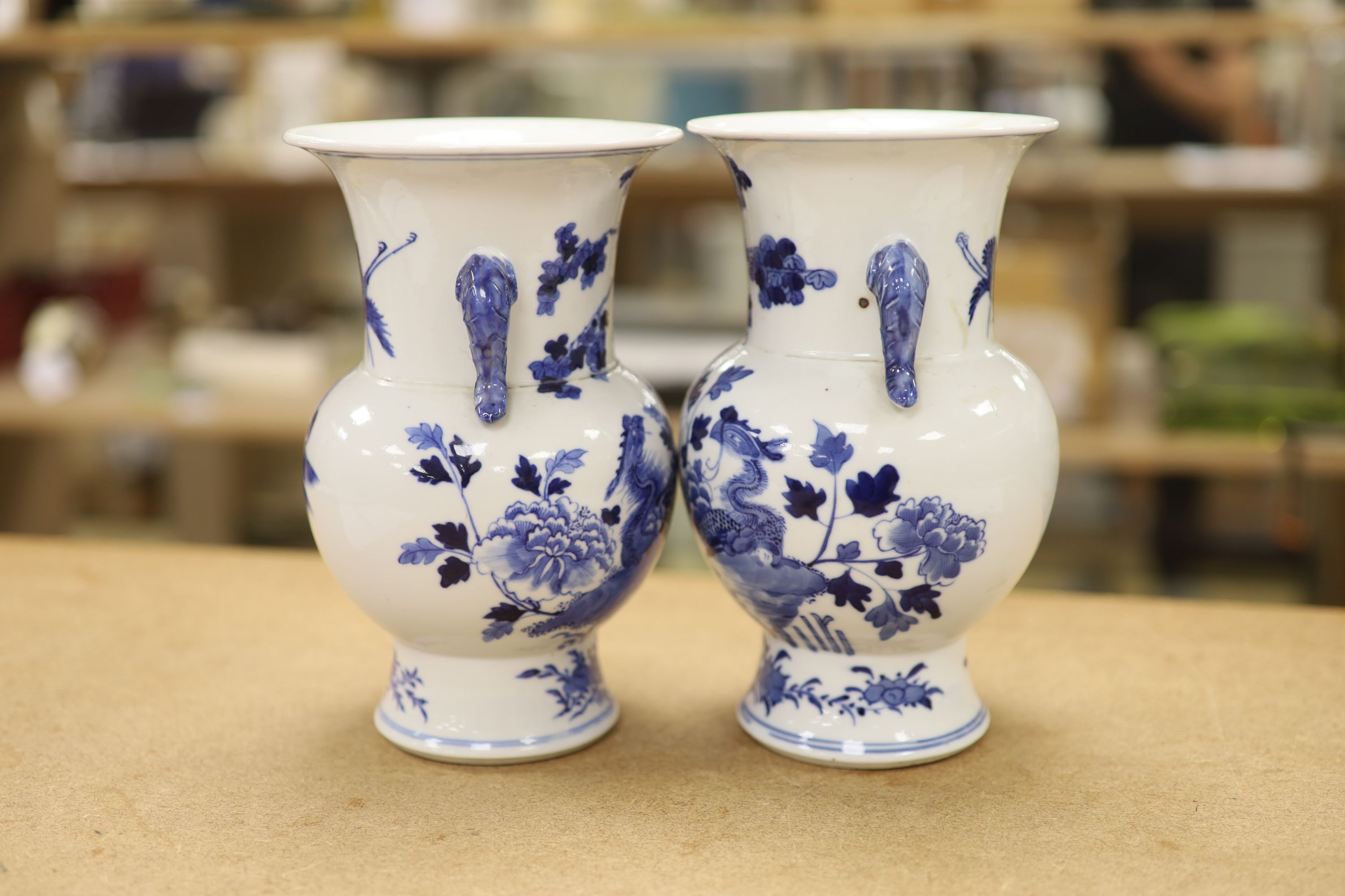 A pair of Chinese blue and white 'phoenix' vases, Kangxi marks but late 19th century, height 20cm (a.f.)